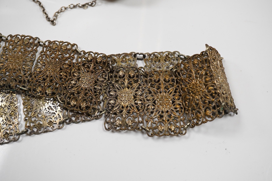 An Edwardian silver vesta case, Birmingham, 1902, 42mm, together with a small Indian white metal box, a pair of white metal Soviet? candlesticks, a plated purse, a plated belt, a hexagonal box and cover stamped MMA and a